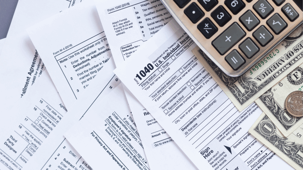 Detailed view of IRS Form 1040 individual tax return with a calculator and money, representing professional tax return preparation by a small business tax accountant. The image highlights accuracy, reliability, and expert support for individual and small business tax filing.